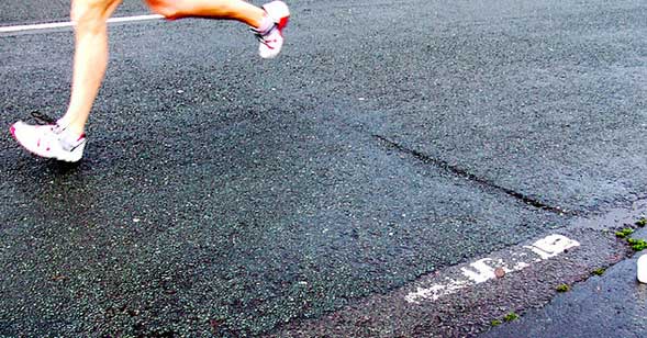 Legs Running on Road